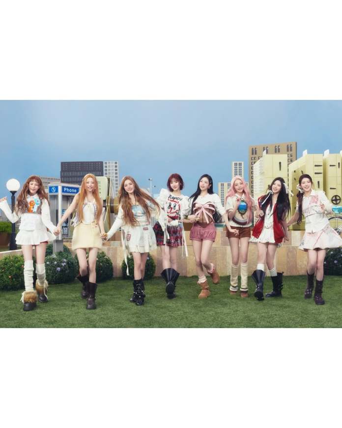 Hearts2Hearts standing together outdoors, smiling and holding hands. They are dressed in colorful and trendy outfits, with a vibrant cityscape in the background.