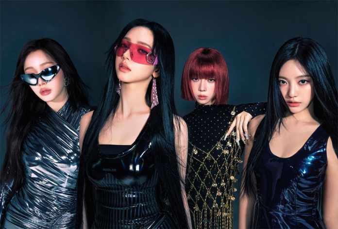 aespa posing together in trendy outfits and sunglasses, featuring a mix of long and short hair and varying hairstyles against a dark background.