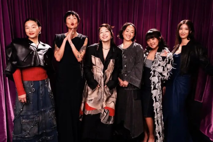 Audrey Nuna, May Hong, Arden Cho, Ji-young Yoo, Rei Ami and EJAE posing together in stylish outfits against a purple velvet backdrop.