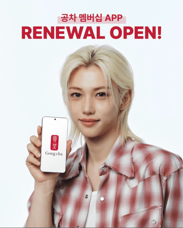 A person with light hair wearing a plaid shirt holds a smartphone displaying the Gong cha logo, promoting the app renewal with the text 'RENEWAL OPEN!' in bold lettering.
