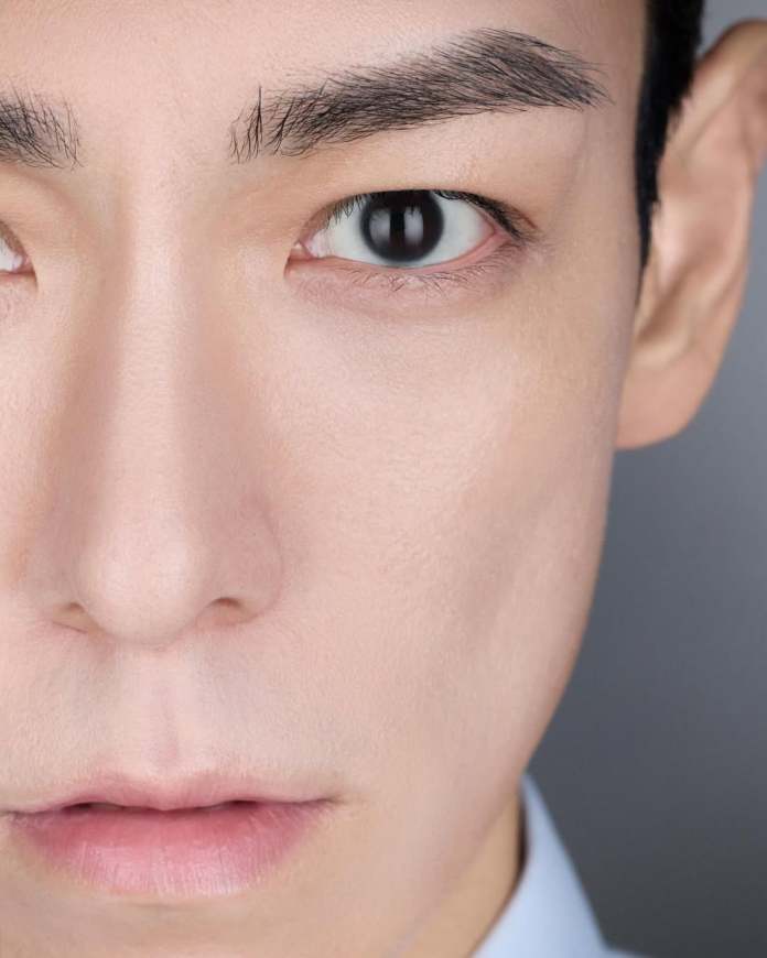 Close-up portrait of a T.O.P  face, focusing on the eyes and facial features, with a neutral expression and soft lighting.