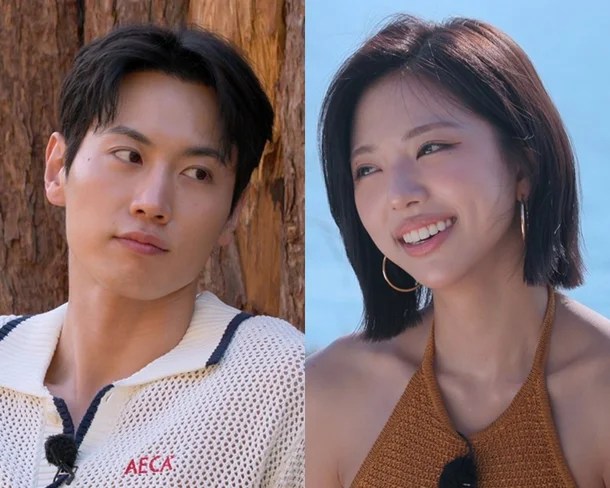 Kim Go Eun and Jo Igeon, with the man looking thoughtful and the woman smiling radiantly, set against a natural background.