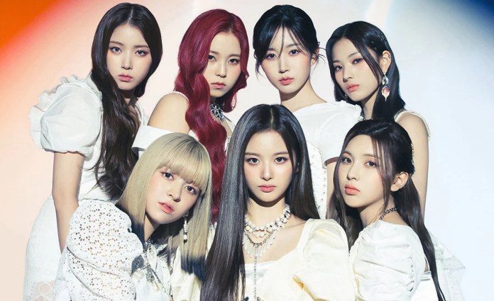 NMIXX dressed in white outfits, posing together with a mix of hairstyles and accessories, against a softly lit background.