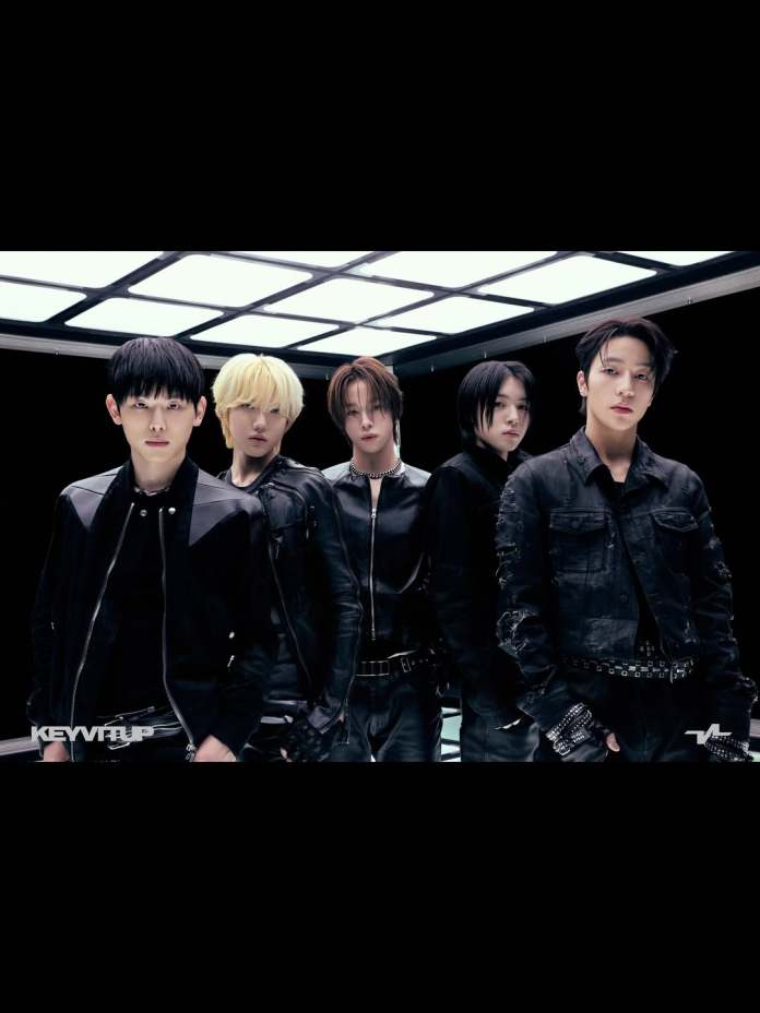 KEYVITUP posed together in a futuristic setting, dressed in dark, stylish outfits with sleek hairstyles.