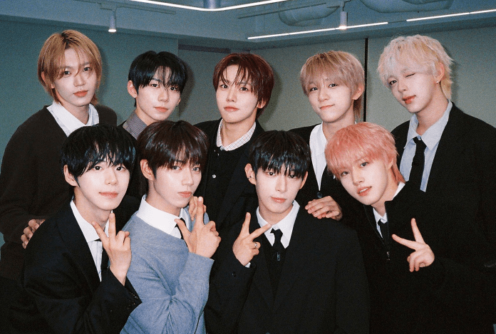 AHOF posing together for a photograph, dressed in smart casual attire, with some making peace signs and smiling.