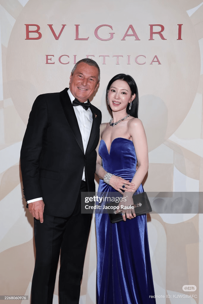 Kim Ji-won in a blue evening gown posing together at a Bvlgari event with an elegant background featuring the brand's logo.