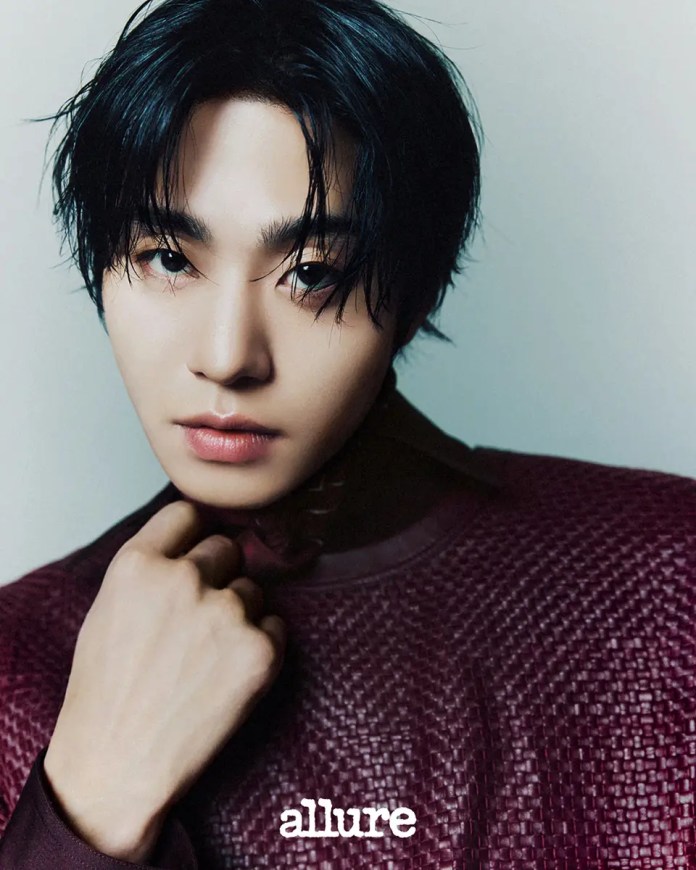 Close-up portrait Ahn Hyo Seop with dark, tousled hair, wearing a textured maroon garment and displaying a thoughtful expression against a neutral background.