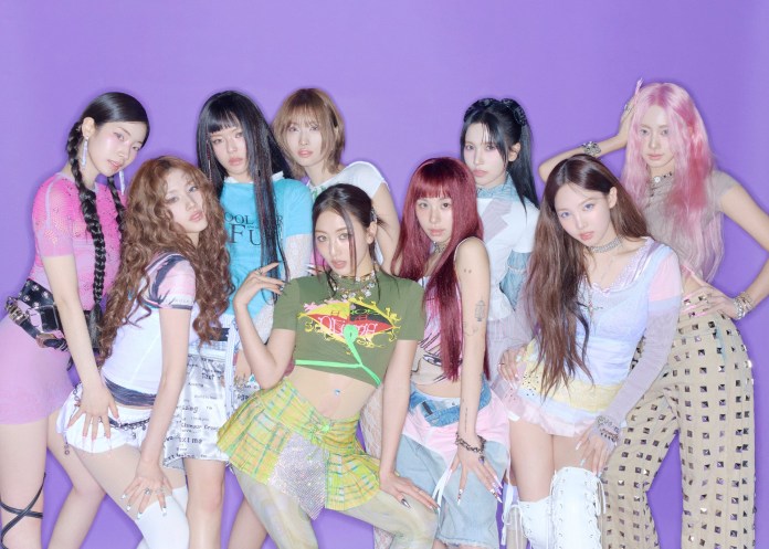 A group of nine young women posing together against a purple background, showcasing trendy, colorful outfits and various hairstyles.