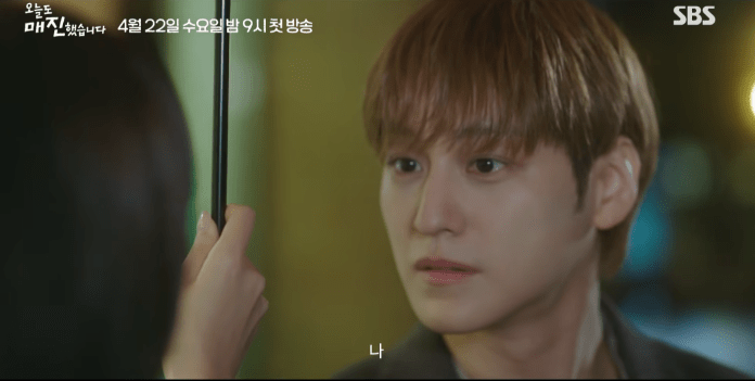 A close-up of Kim Bum with light brown hair, looking intently at someone holding a black umbrella. The scene has a warm and emotional atmosphere.