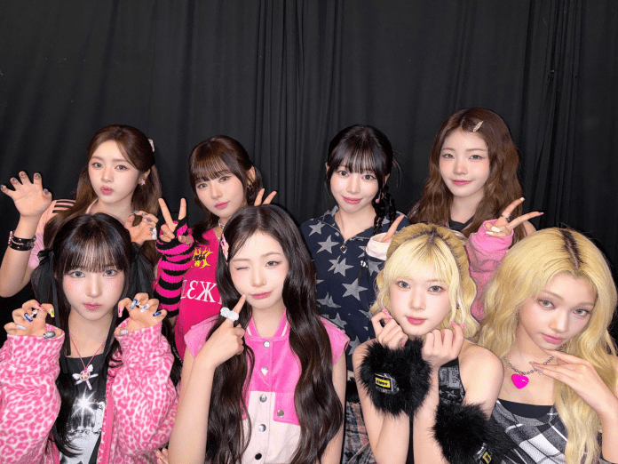 UNIS posing together in a colorful and playful manner, showcasing various fashion styles against a black backdrop.