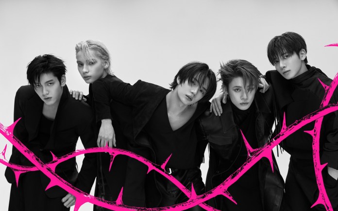 TXT members poses together in a stylish black and white photo, wearing matching dark outfits, with a vibrant pink thorny design overlaying the image.