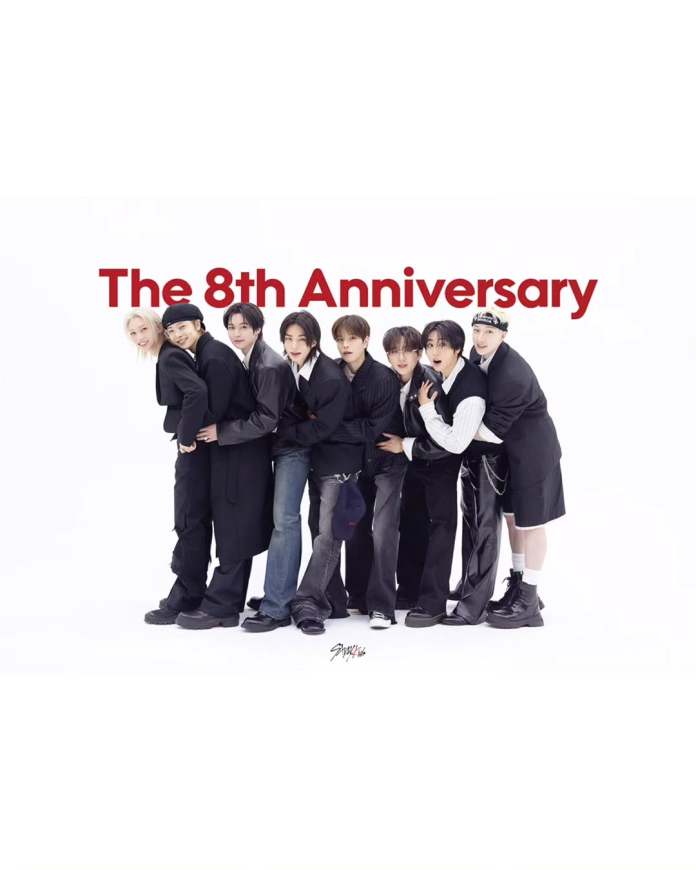StrayKids celebrating a milestone with the text 'The 8th Anniversary' prominently displayed in red above them.
