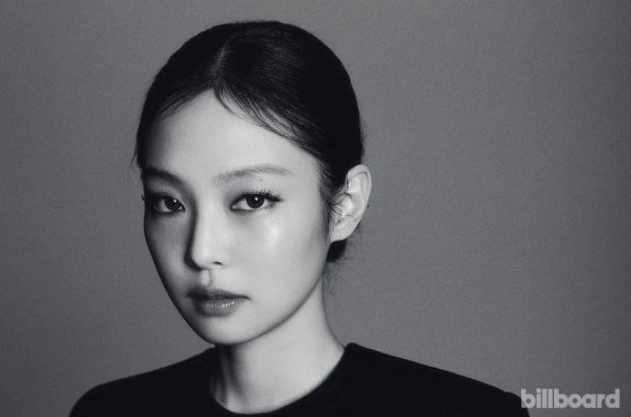 Jennie with sleek hair pulled back, showcasing her striking features and intense gaze.