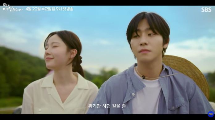 Ahn Hyo Seop sitting outdoors with a scenic background, both smiling and enjoying the moment.