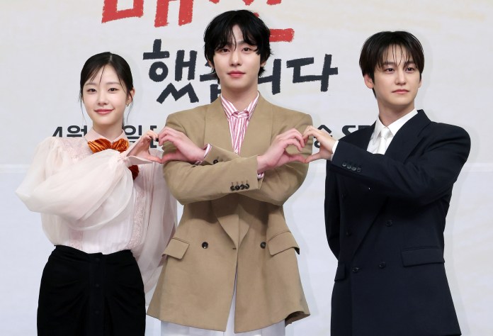 Ahn-hyo Seop, Chae-Won Bin and Kim Bum pose together, making heart shapes with their hands against a promotional backdrop.