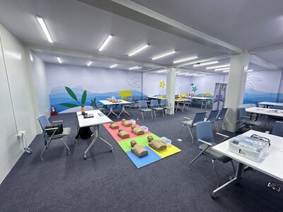 A training room at the Cebu Pacific Training Academy equipped with mannequins for emergency response drills, tables, chairs, and educational materials, designed for hands-on instruction in aviation safety procedures