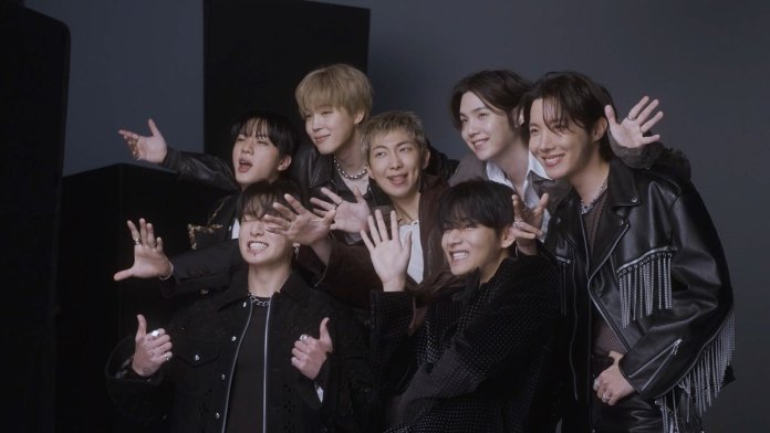 BTS posing together with playful expressions, showcasing a fun and lively atmosphere.