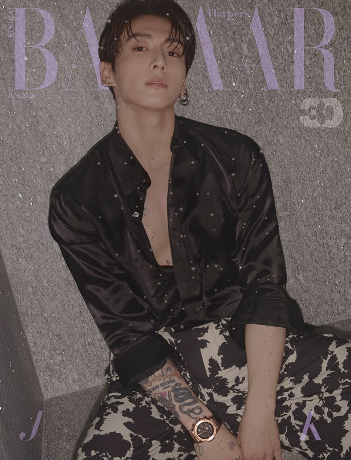 Jungkook dressed in a black button-up shirt sits against a textured wall, wearing patterned pants and a stylish watch. The image has a muted, artistic aesthetic with a magazine cover layout.