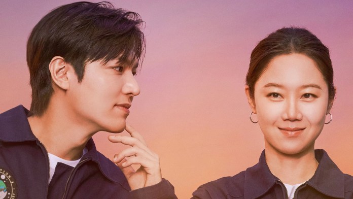 Two people in casual outfits, positioned against a gradient background. One person is looking intently at the other, who is smiling slightly.