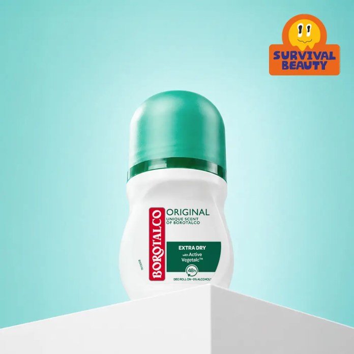 Roll-on deodorant bottle of Borotalco Original Extra Dry with a green cap, placed on a white surface against a mint green background.