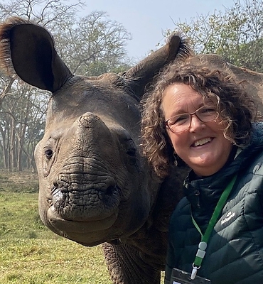 Professor Wendy Wright takes a selfie with an orphaned one-horned rhinoceros at Chitwan National Park, Nepal.