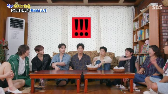 A group of six people sitting around a low table in a cozy room, appearing to engage in a lively conversation. A large red graphic with exclamation marks is displayed in the background.