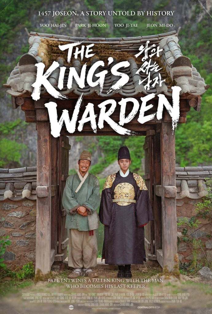 Park Ji-hoon standing at the entrance of a traditional Korean building, dressed in historical attire. The person on the left wears a simple outfit with a friendly smile, while Park Ji-hoon on the right is in an ornate royal costume, looking serious. Text overlay reads 'The King's Warden' and mentions a historical story set in 1457 Joseon.
