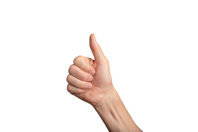 A hand making a thumbs-up gesture against a white background.