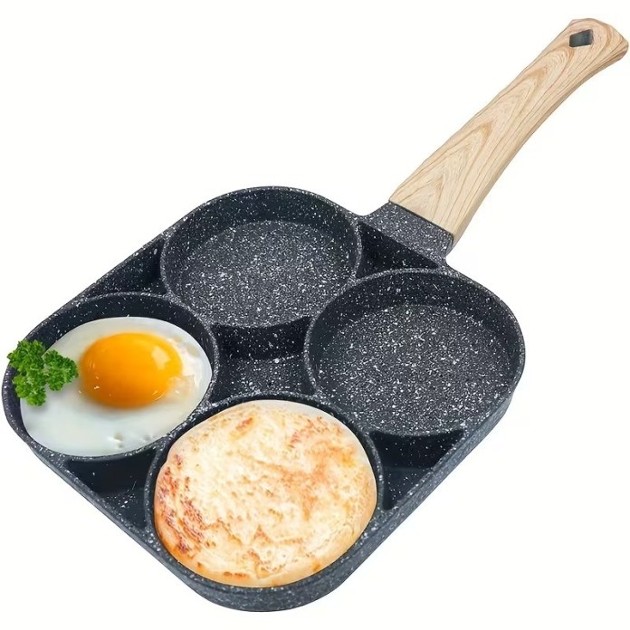 A non-stick multi-section frying pan with a wooden handle, featuring one fried egg, one round bread, and two empty sections.