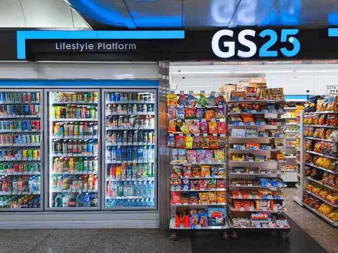 Interior view of a GS25 convenience store featuring a refrigerated beverage display and snack shelves, under a sign that reads 'Lifestyle Platform'.