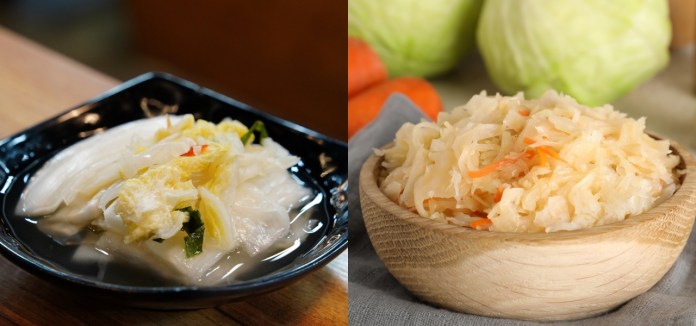 A black dish containing sliced pickled cabbage with herbs and chili, alongside a wooden bowl of shredded sauerkraut with carrots.