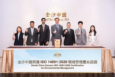 Executive Vice President, General Counsel and Company Secretary of Sands China Ltd. Dylan Williams (centre) and Vice President of Sustainability and Environmental, Social and Governance Pranav Jampani (third from left), and other team members display the company’s ISO 14001:2026 certification. 