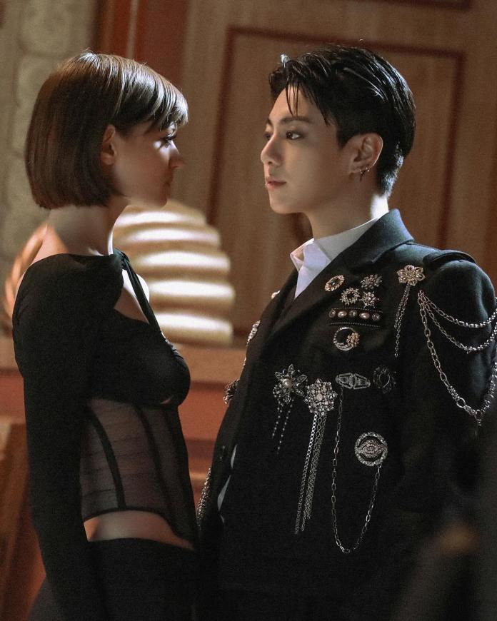 Jung Kook in a decorated black suit, both in a dramatic setting.