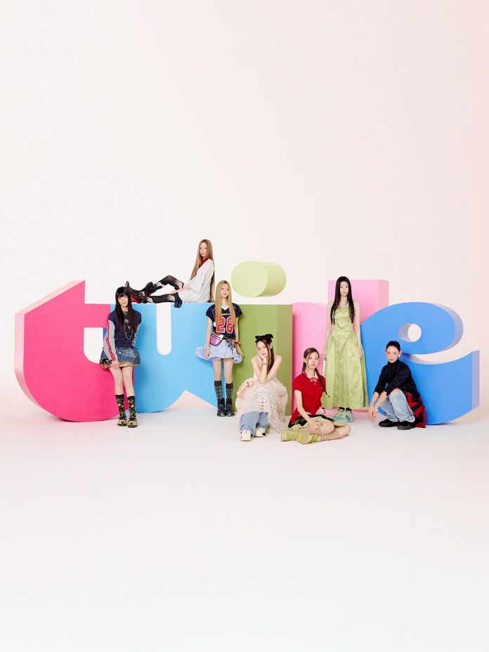TUIDE members posing playfully around vibrant, oversized letters spelling 'twice.' They are dressed in colorful and trendy outfits, showcasing a mix of styles and expressions against a soft pastel background.