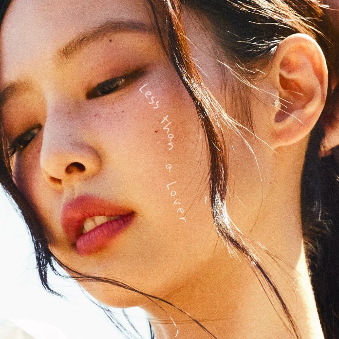Close-up of Jennie's face with soft lighting, featuring subtle freckles and natural makeup. The text 'Less than a Lover' is artistically placed on the side.