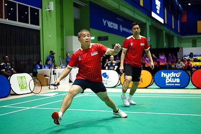 Minister Edwin Tong (left), on court alongside Indonesian Olympic Gold Medallist Hendra Setiawan (right) during the VIP exhibition match.