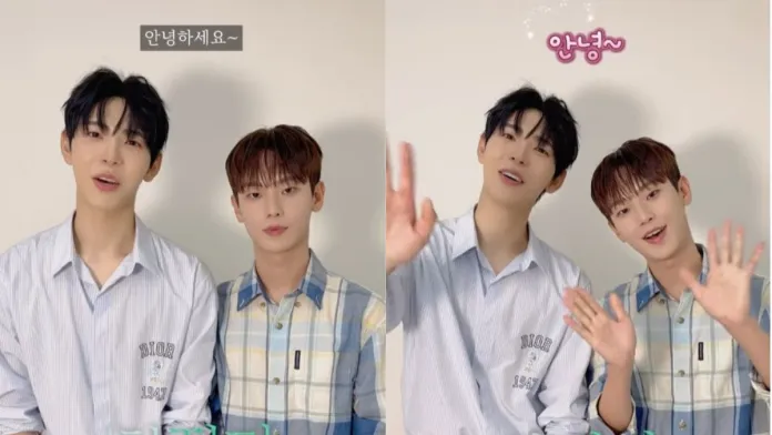 Seong In-ho and Kim Do-min standing side by side, smiling and waving at the camera. Seong In-ho  on the left is wearing a light blue striped shirt, Kim Do-min on the right is dressed in a checkered shirt. A greeting in Korean is visible above them.