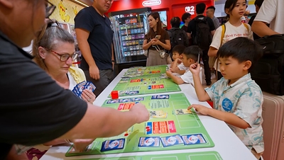 Young and old gather around Pokémon Trading Card Game, turning the simple act of playing into a cherished family ritual that bridges generations and brings everyone together at the table.