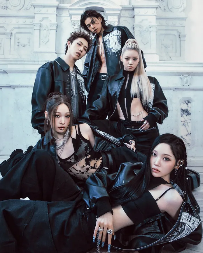 A group of five fashionably dressed individuals posing creatively in a stylish, modern setting. They are wearing black outfits with unique designs, showcasing an edgy aesthetic.