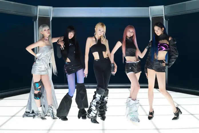 Five women posing in stylish outfits against a futuristic backdrop, showcasing dark and metallic fashion with various hairstyles.