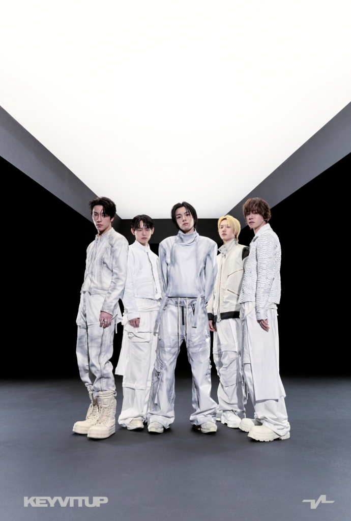 KEYVITUP dressed in fashionable white outfits standing in a modern, minimalistic environment with dramatic lighting.