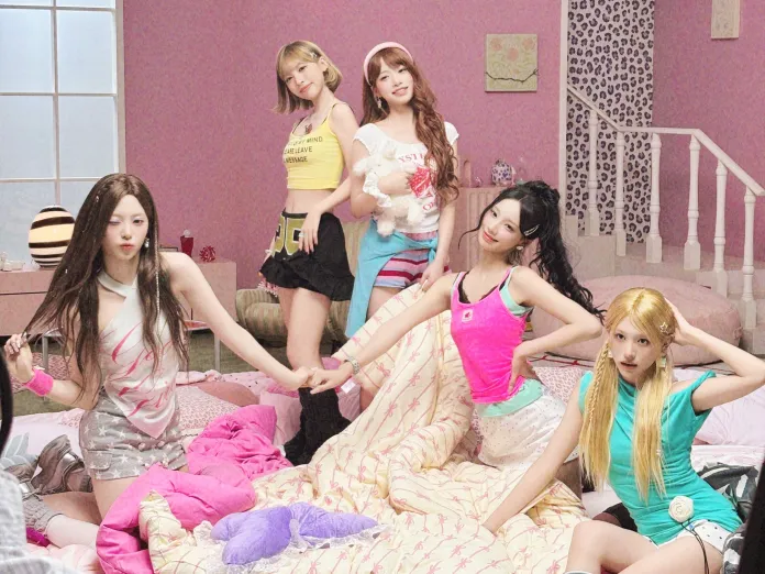 RESCENE members posing together in a colorful bedroom with a pink theme, dressed in casual, trendy outfits and playfully interacting with each other.