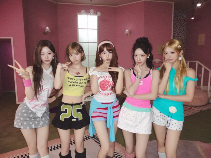 RESCENE members posing together in a colorful, pastel-themed room, wearing playful, casual outfits. They are showcasing various hairstyles and making fun expressions.