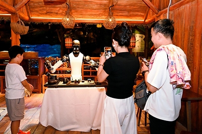 Visitors interact with AGIBOT robots through games, learning activities and other hands-on experiences at Chimelong Spaceship Park.