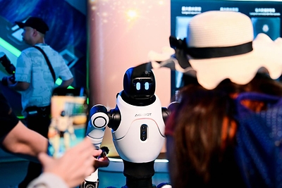 Visitors interact with AGIBOT robots through games, learning activities and other hands-on experiences at Chimelong Spaceship Park.