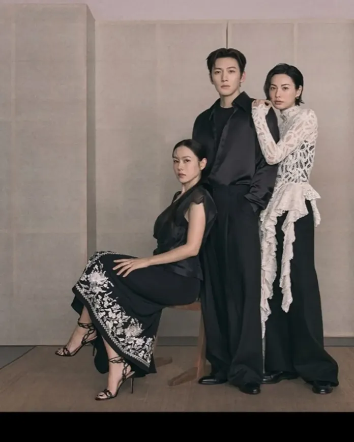 Ji chang wook, son ye jin and nana posing in formal attire. The woman seated at the front wears a black dress with floral embroidery, while the standing man and woman are dressed in black outfits, one featuring a white detailed top.
