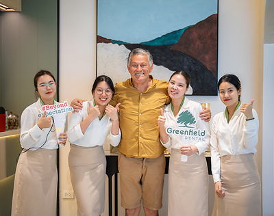 International patients with Greenfield Dental care team in the clinic lounge