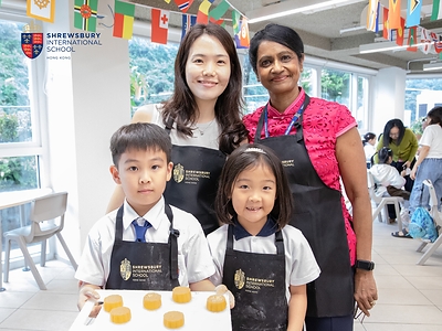 Shrewsbury Hong Kong Principal, Priya Kanthan, with students and a parent.