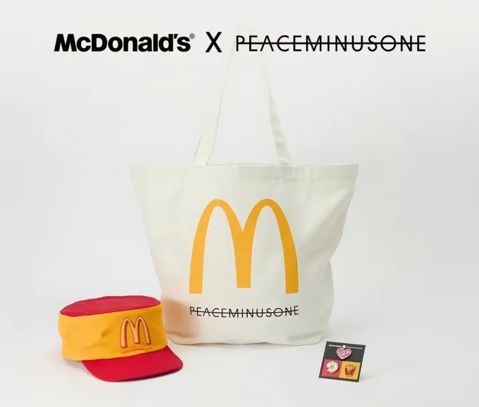 McDonald's and PEACEMINUSONE collaboration featuring a white tote bag with the iconic golden arches logo, a red and yellow cap, and a small card with decorative graphics.