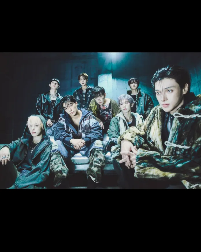 ATEEZ members posing together in a dimly lit urban setting, wearing a mix of casual and edgy streetwear.